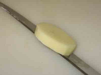 A thick potato slice for fasolakia.