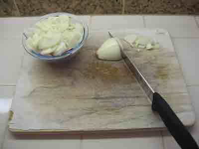 Slicing onions for greek green beans.