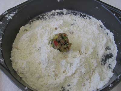 Put meat in flour for greek recipe keftedakia kalokairinoi summer meatballs.