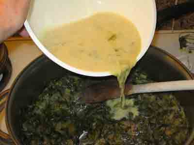 Pouring avgolemono into the pot.