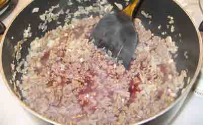Simmering the beef in wine for greek recipe makaronia me kima, greek spaghetti with meat sauce.