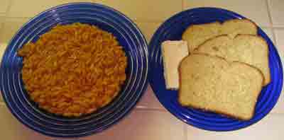 Orzo or manestra in tomato sauce with bread and feta.