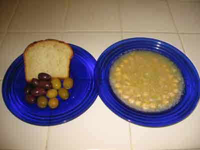 Revithia soup served with bread and olives.