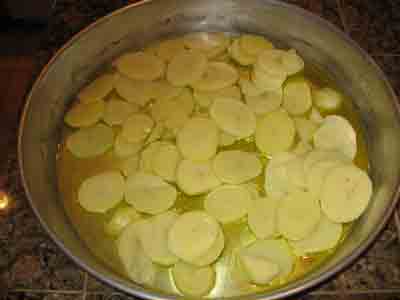 Sliced potatoes in oil.