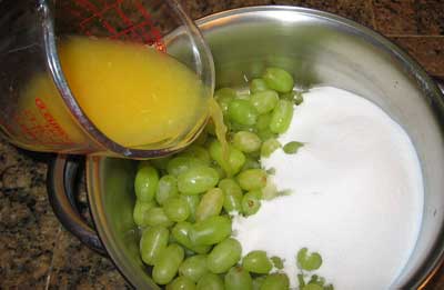Mixing grapes and other ingredients for greek spoon sweet stafyli gliko.