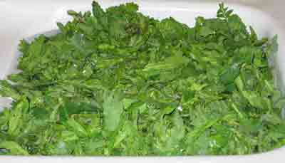 Mustard greens being washed for greek recipe vrouves.